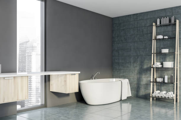 istock Gray bathroom corner with tub and rack 1189997688