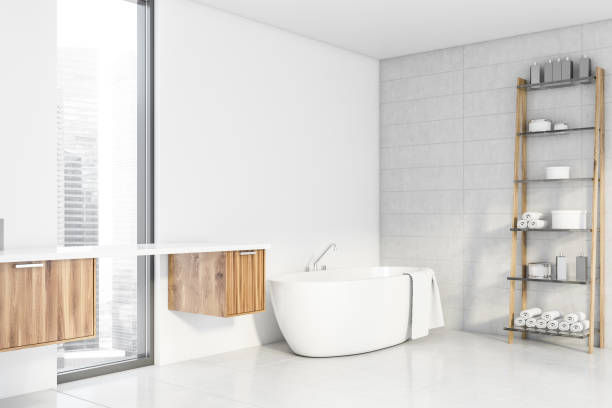 istock White bathroom corner with tub and shelves 1189997981