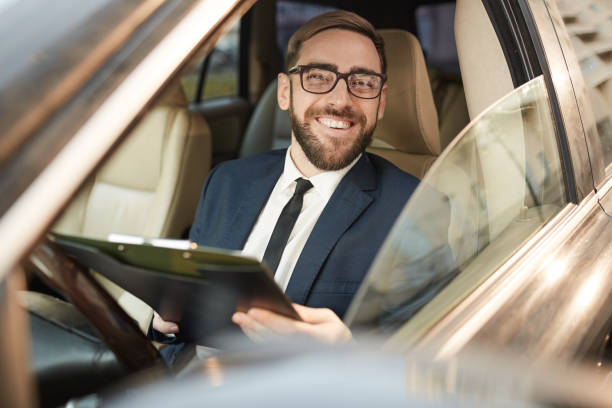 istock Successful young businessman in the car 1189998086