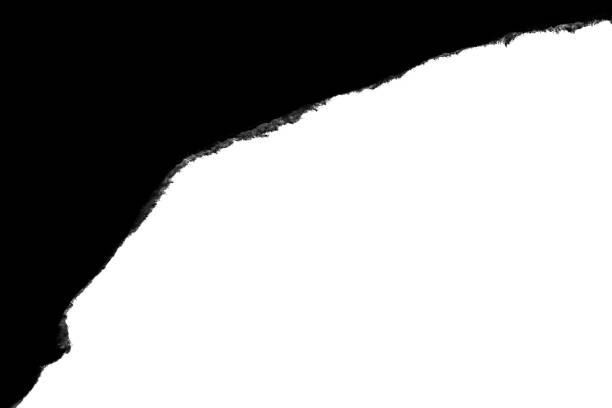 istock Black paper with torn edges isolated with a black isolated background inside. 1190001550