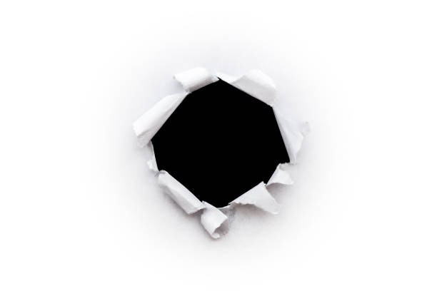 istock A round hole in white paper with torn edges isolated on a white background with a black isolated background inside. 1190001568