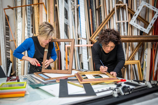 istock Restorer and framer laboratory craftswomen: Preparing frames 1190001739