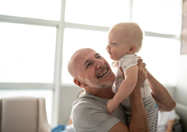 istock Smiling grandfather holding his grandson 1190002679