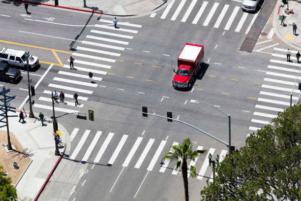 Street scene in Los Angeles, fire truck speeding through the intersection, aerial view, USA.