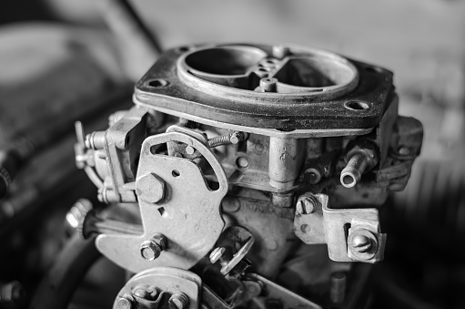 Carburetor without top cover. Without people. Selective focus. Blurred background. Black and white photo