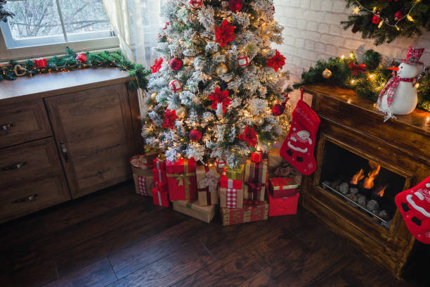 istock Decorated Christmas Tree Near Fireplace at Home 1190007138