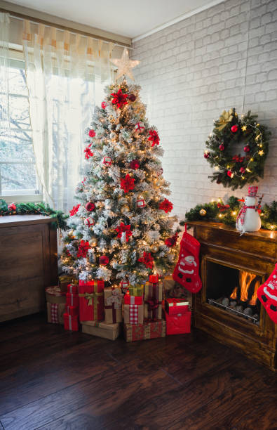 istock Decorated Christmas Tree Near Fireplace at Home 1190007366