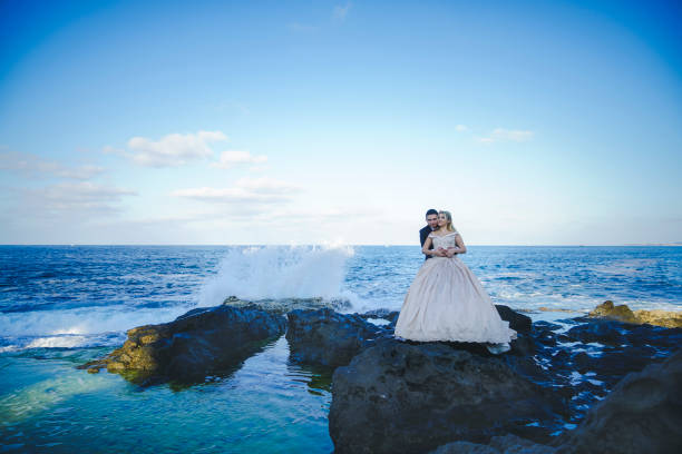 istock bride and groom poses in front of landscape 1190008276