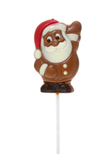 A Father Christmas chocolate character on a stick - white background