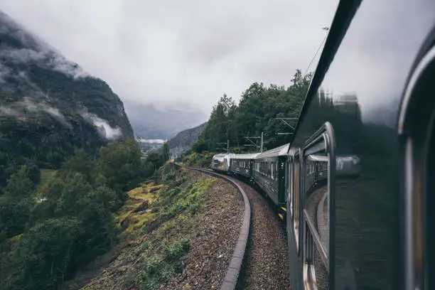 Photo of Reflection in train window of Flamsbana mountain railway in Flam, Norway