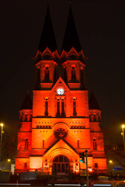 Wiesbaden, Germany - November 25, 2019: Orange coloured illuminated Ringkirche of Wiesbaden in the city center during the worldwide  \