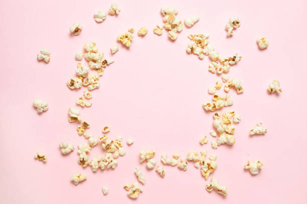 Top view of popcorn frame on pink background with copy space Top view of popcorn frame on pink background with copy space. View movie banner concept popcorn snack bowl isolated stock pictures, royalty-free photos & images