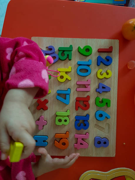 istock numbers colors child hand, childhood,  playing and laarning maths 1190013959