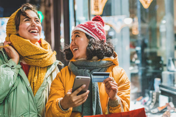 istock Two young woman outdoors using mobile banking for shopping 1190016010