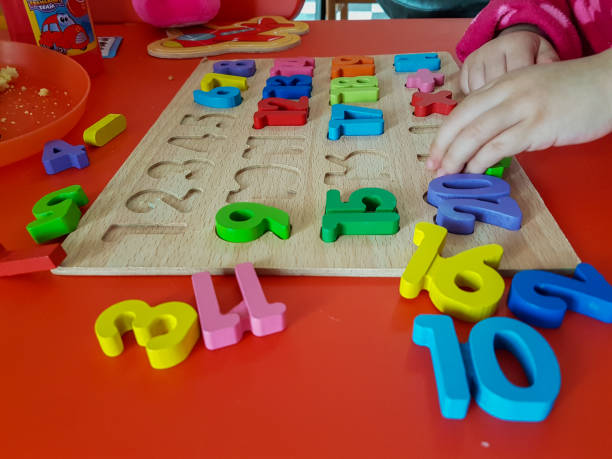 istock numbers colors child hand, childhood,  playing and laarning maths 1190016405