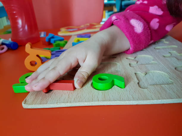 istock numbers colors child hand, childhood,  playing and laarning maths 1190017492