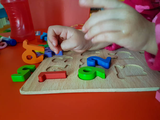 istock numbers colors child hand, childhood,  playing and laarning maths 1190018003