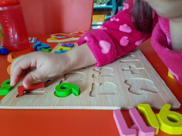 istock numbers colors child hand, childhood,  playing and laarning maths 1190018141
