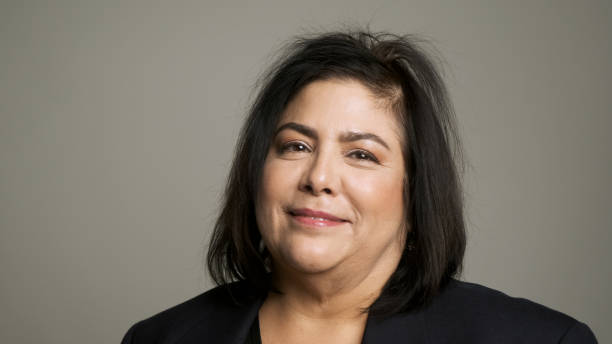istock Mature woman posing looking at the camera smiling (real latino women) 1190018828