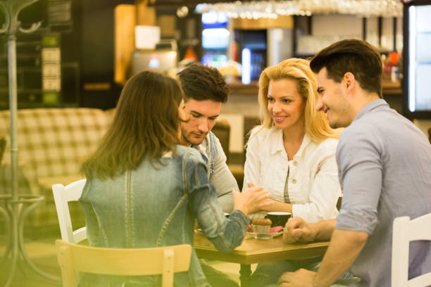 istock Group of young adults talking in a cafe 1190020070