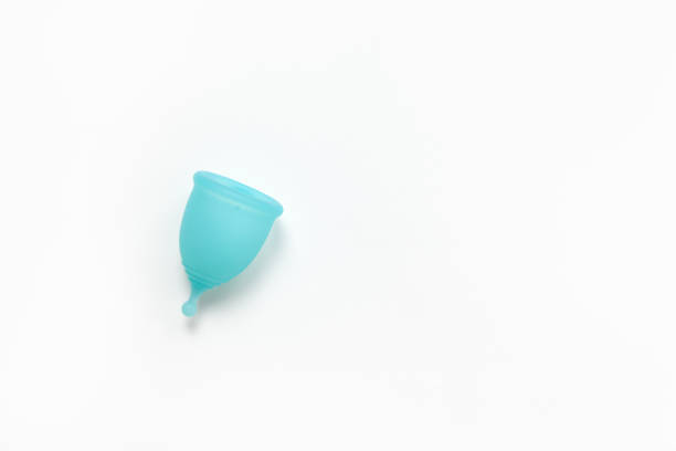 istock Turquoise menstrual cup on white background. Concept zero waste, savings, minimalism, environmental conservation, sustainable lifestyle. Feminine hygiene product, flatlay, copy space. Horizontal 1190023186