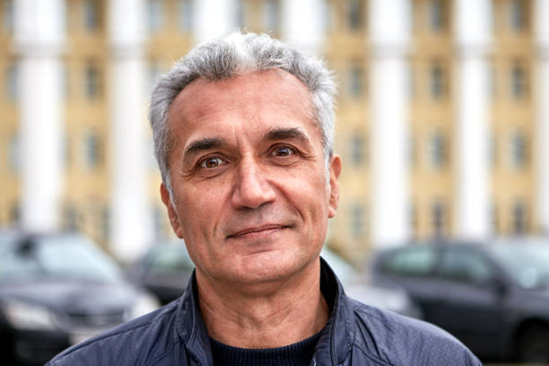 istock Mature handsome man is posing outdoors. 1190026734