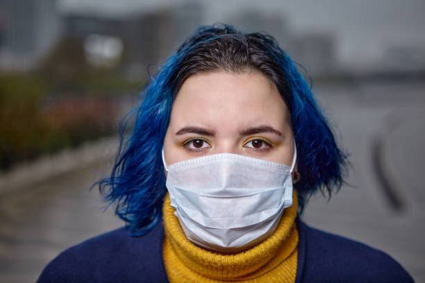 istock Young woman in protective medical mask from flu. 1190026741