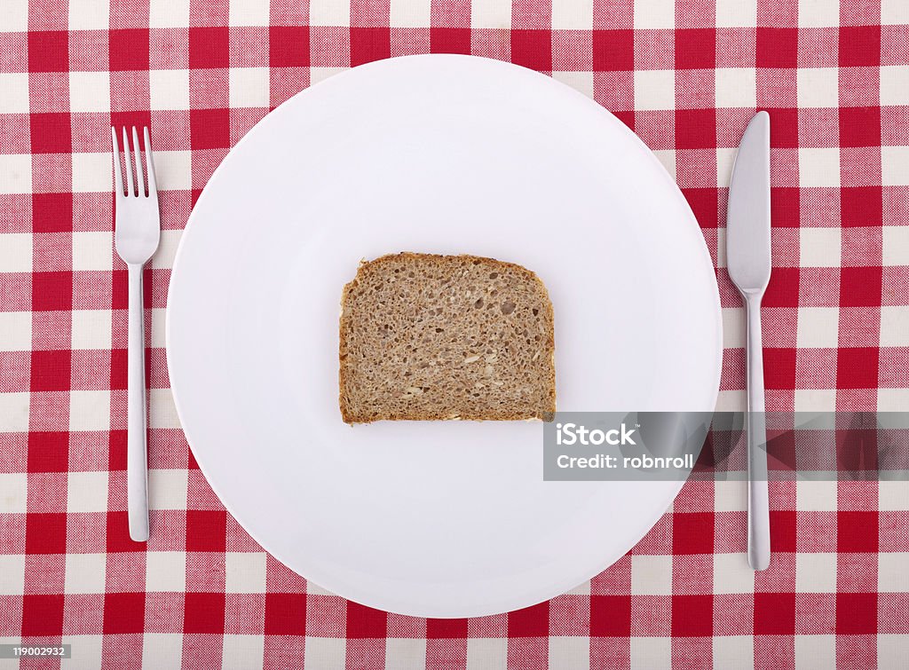 Tischtuch mit Gabel, Messer und ein Stück Brot - Lizenzfrei Brotscheibe Stock-Foto