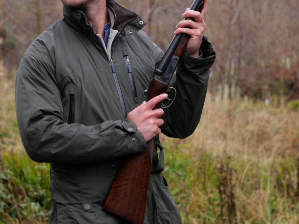 istock A man looking over his shoulder during a pheasant shoot, as he stands ready with his shotgun. 1190029896
