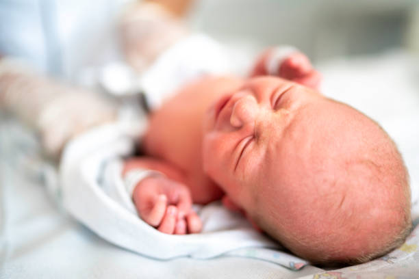 istock Newborn baby sleeping at hospital 1190033498