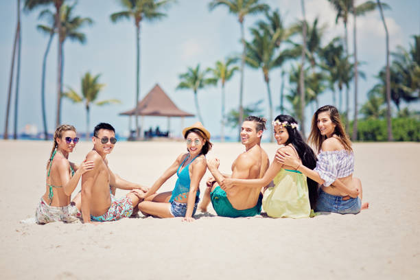istock Happy friends are making fun on the beach 1190033533