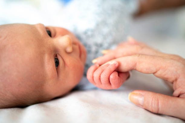 istock Newborn holding mother's hand 1190033581