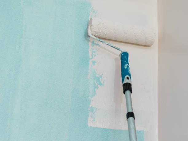 istock Person applying paint on wall 1190033715