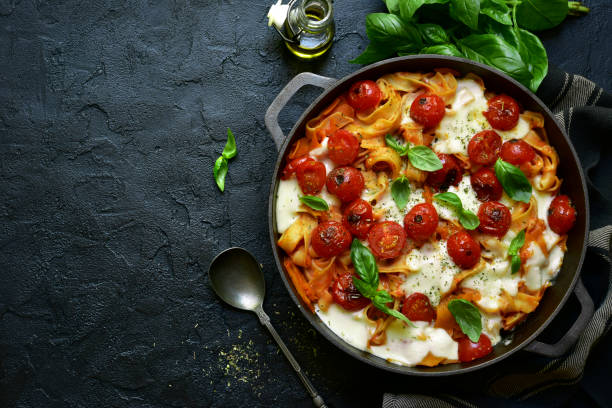 istock Pasta casserole with tomatoes and mozzarella cheese in a cast iron pan 1190036536