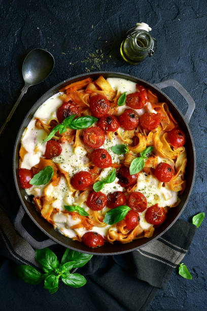 istock Pasta casserole with tomatoes and mozzarella cheese in a cast iron pan 1190036537