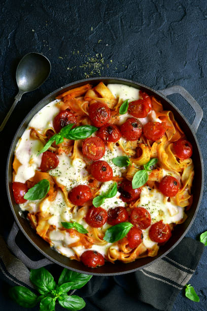 istock Pasta casserole with tomatoes and mozzarella cheese in a cast iron pan 1190036552