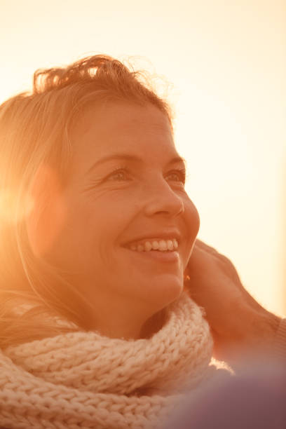 istock Beautiful smiling woman sunset flare 1190036781