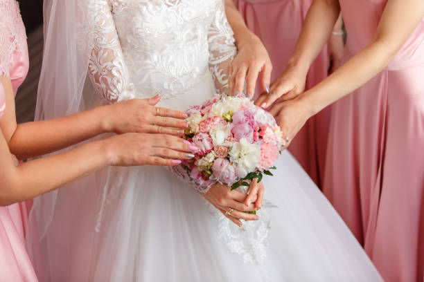 istock Bride and bridesmaids holding wedding bouquet 1190043625
