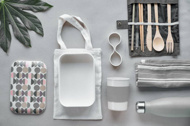 istock Creative top view, zero waste packed lunch kit, takeaway lunch box set on cotton bag, organizer of bamboo cutlery, bamboo lunch box and reusable cup. Sustainable lifestyle, flat layout on craft paper. 1190044600