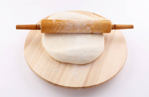 istock preparation Dough and Rolling pin on wood circle shape on white background 1190044601