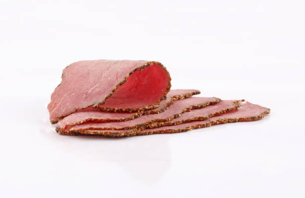 slices perfectly arranged of roast beef on white background roastbeef slices perfectly arranged of roast beef  isolated on white background pastrami photos stock pictures, royalty-free photos & images