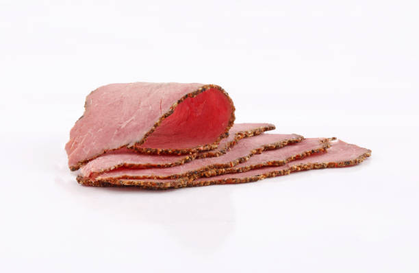 slices perfectly arranged of roast beef on white background - roast beef fotos imagens e fotografias de stock