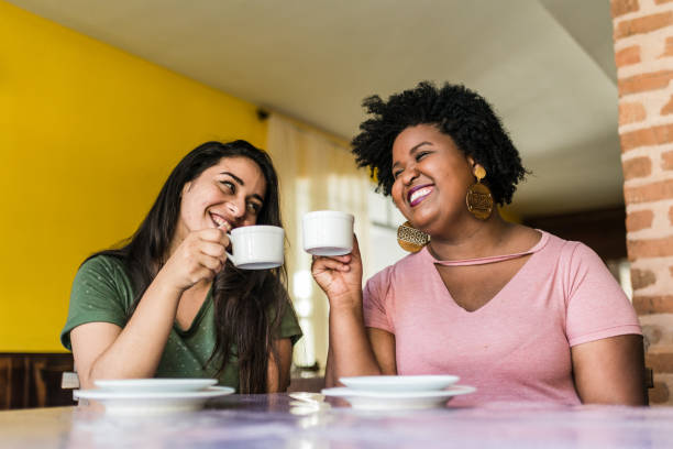 istock Smiling friends toasting cups of coffee 1190046946