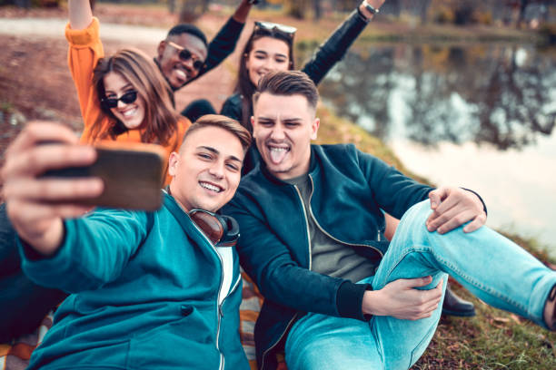 istock Happy Friends Taking Selfie In Park 1190047083