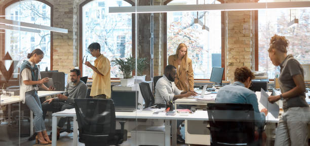 working together on project. group of young mixed race business people working together in the creative office. team building concept. office life - inside of office technology people imagens e fotografias de stock