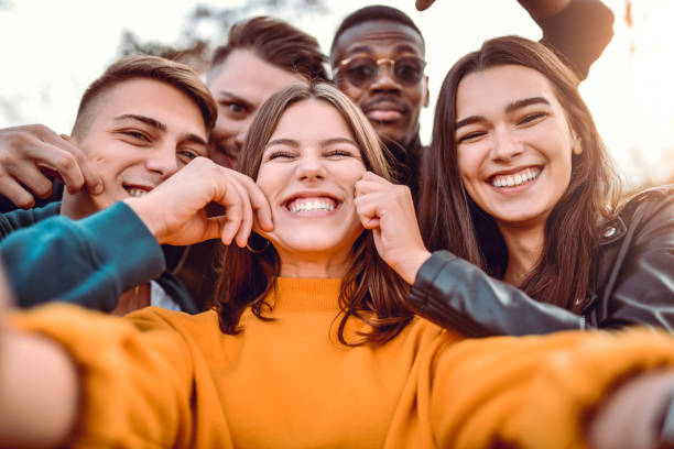 istock Friends Taking Bizarre Selfie In Park 1190058352