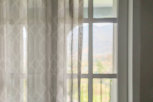 istock window curtain with green garden abstract blur background 1190059370