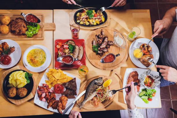 istock man at the big table with food. 1190060073