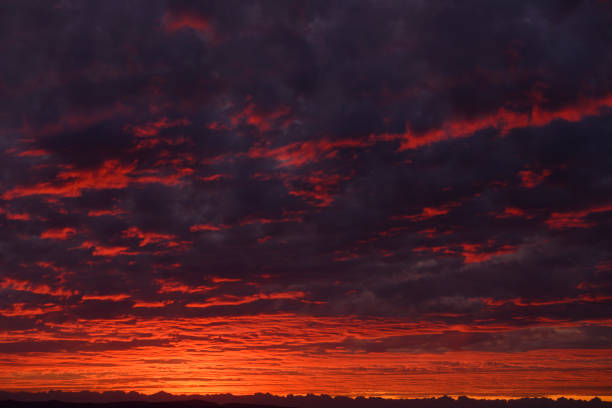 Sunset with dark clouds at California coast.