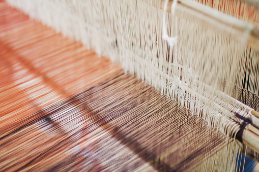 Weaving equipment Household weaving - Detail of weaving loom for homemade silk Used for silk weaving or textile production of Thailand Native cotton weaving using a Loom of weaving, which is folk wisdom, showing the ingenuity in creating Thai art.